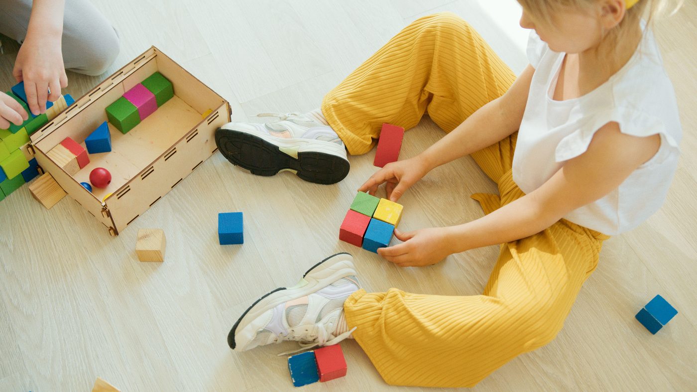 A toddler playing with colorful blocks