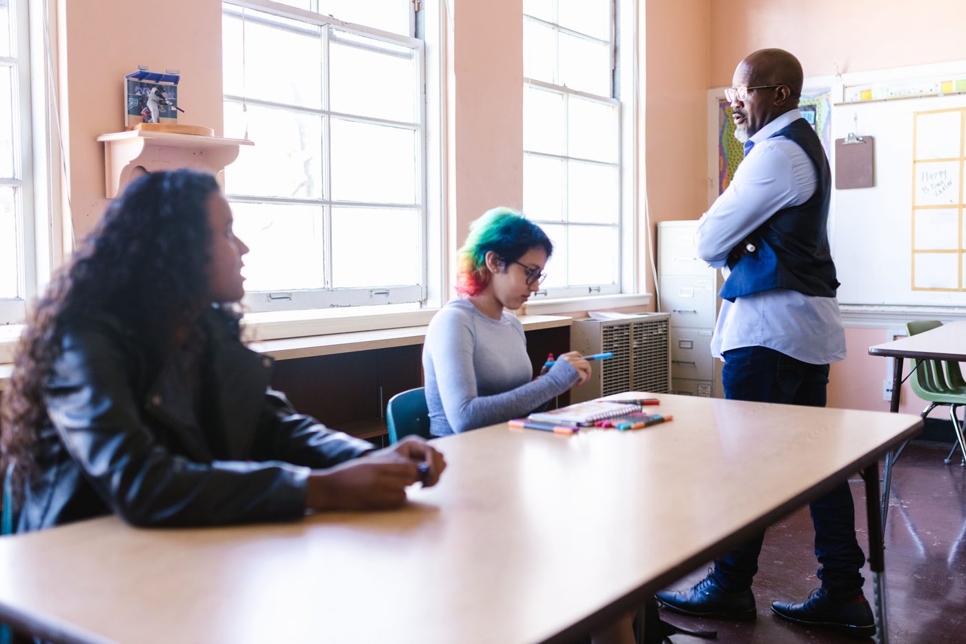 Young students working together at a table in a bright classroom