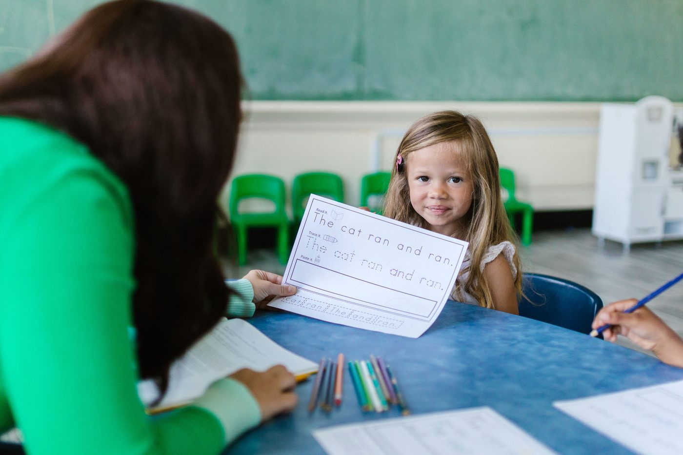 Children working together on an activity at a classroom table